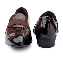 Pair of brown loafers with snake skin pattern on a white background