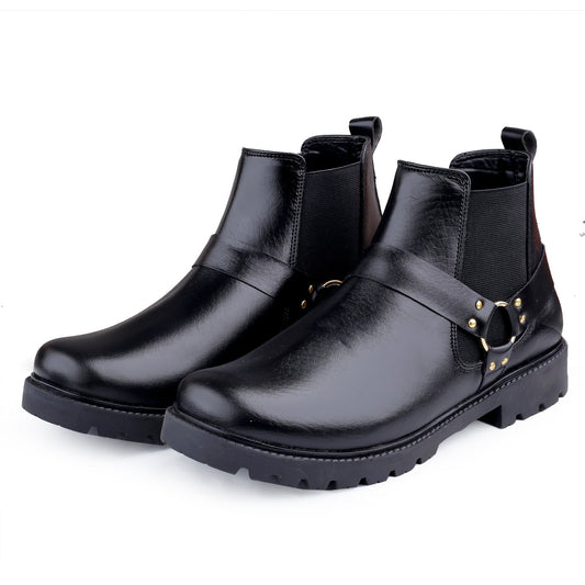 Pair of black leather boots with gold buckles on a white background