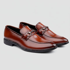 Pair of brown loafers with metallic buckles on a white background