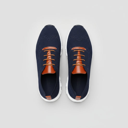 Navy and orange sneakers on a wooden floor