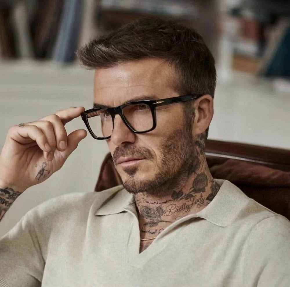 Stylish man wearing black frame blue light blocking glasses for men while sitting comfortably