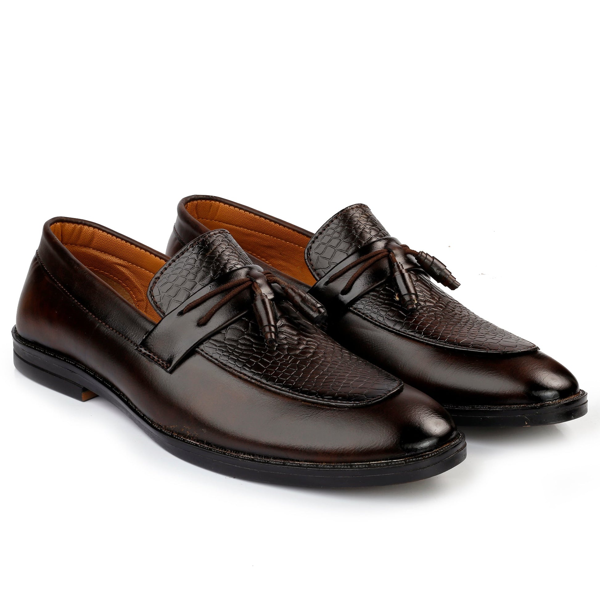 Pair of brown leather loafers with tassels on a white background