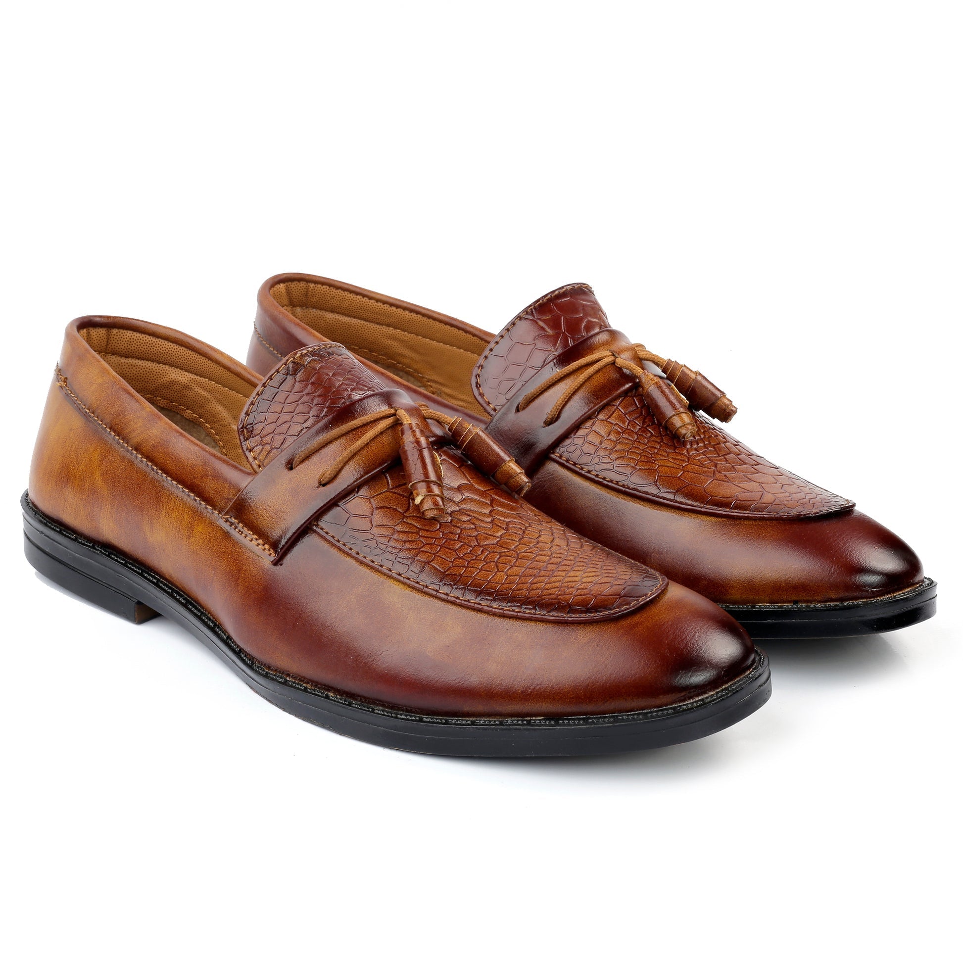 Pair of brown leather loafers with tassels on a white background