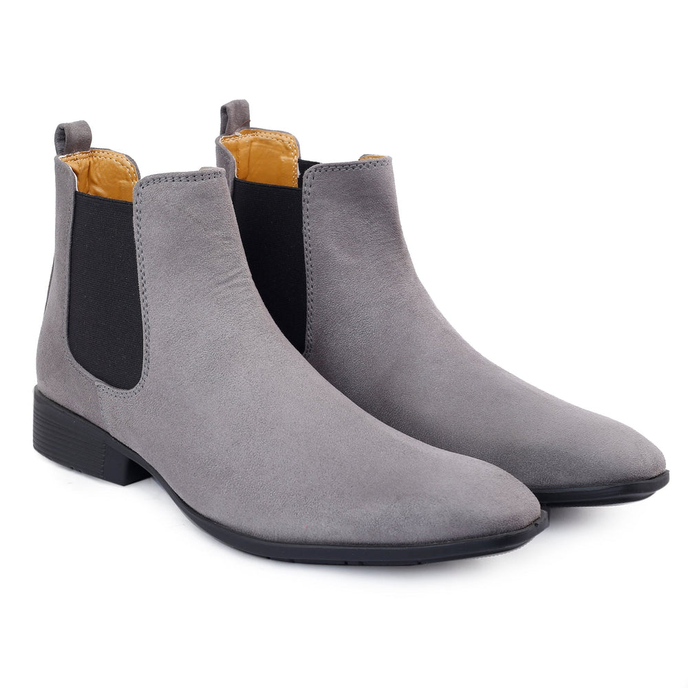 Pair of gray Chelsea boots on a white background