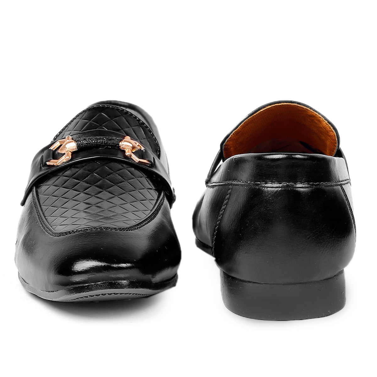 Black loafers with a decorative buckle on a white background