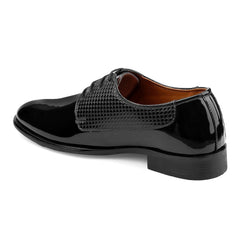 Black patent leather shoe with a textured strap on a white background