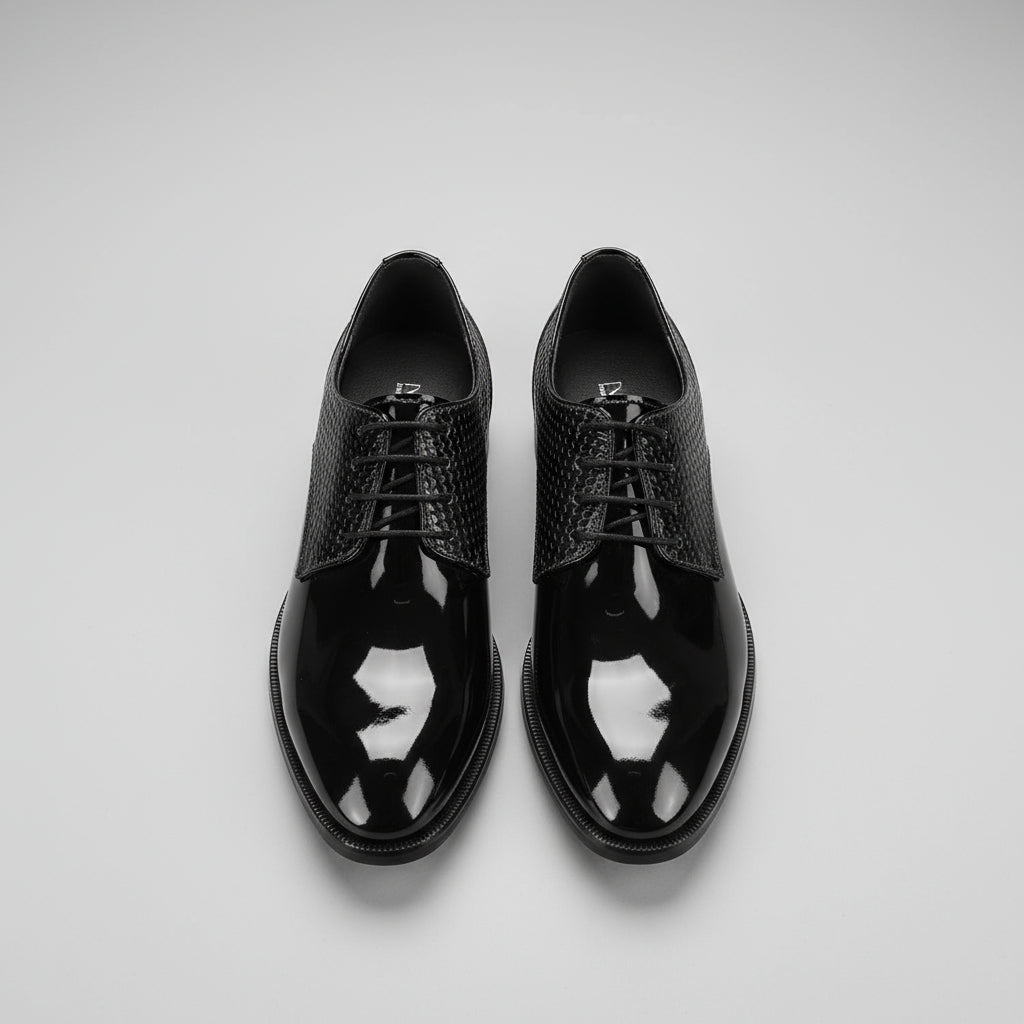 Black patent leather shoes on a wooden floor