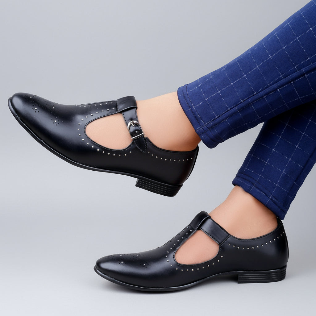 Black shoes with a strap worn by a person on a wooden floor