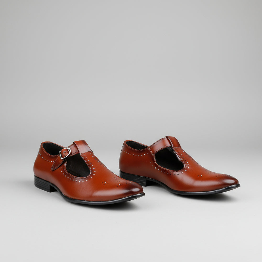 Brown leather shoes with a strap on a white platform against a green curtain background