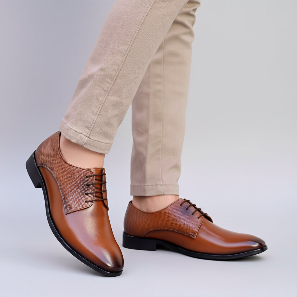 Brown leather shoes worn with beige pants on a neutral background