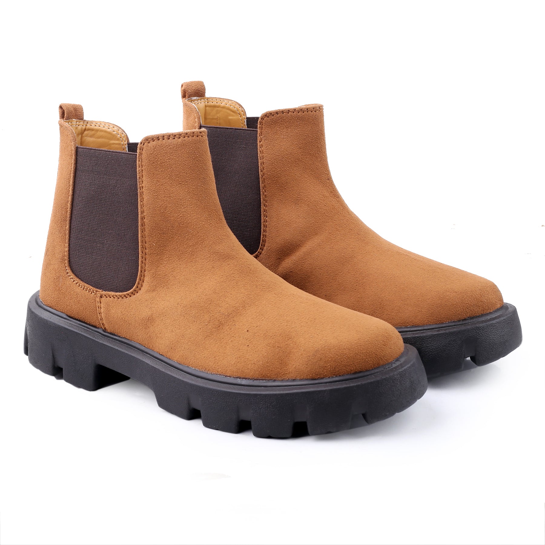 Pair of brown Chelsea boots with black soles on a white background