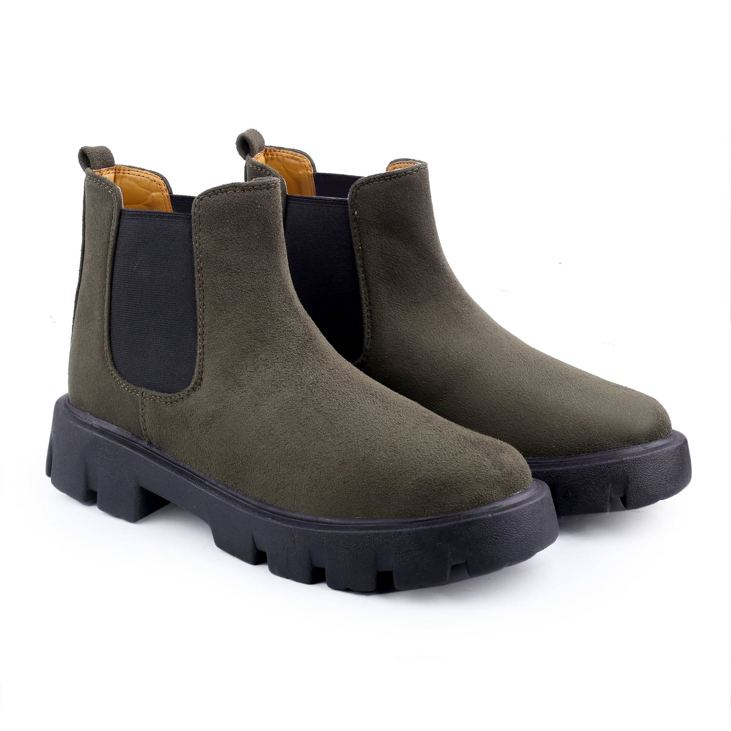 Pair of green Chelsea boots with black soles on a white background