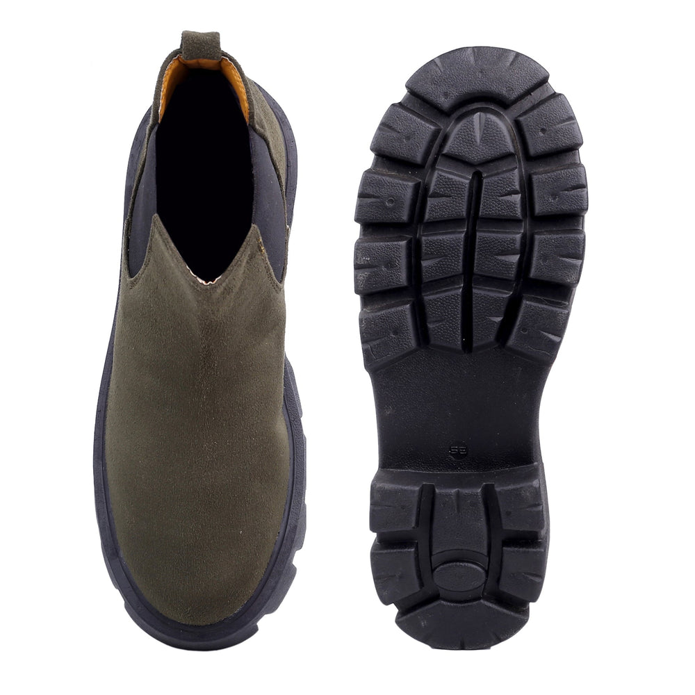 Brown Chelsea boot with black sole on a white background