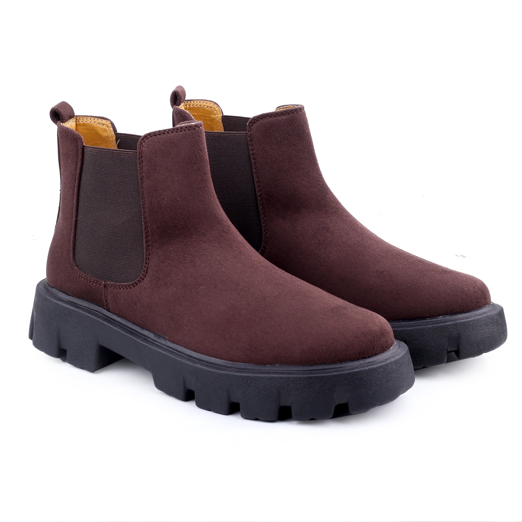 Pair of brown Chelsea boots with black soles on a white background