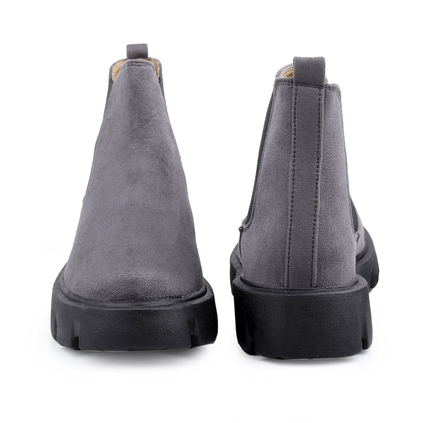 Gray suede boots with black soles on a white background