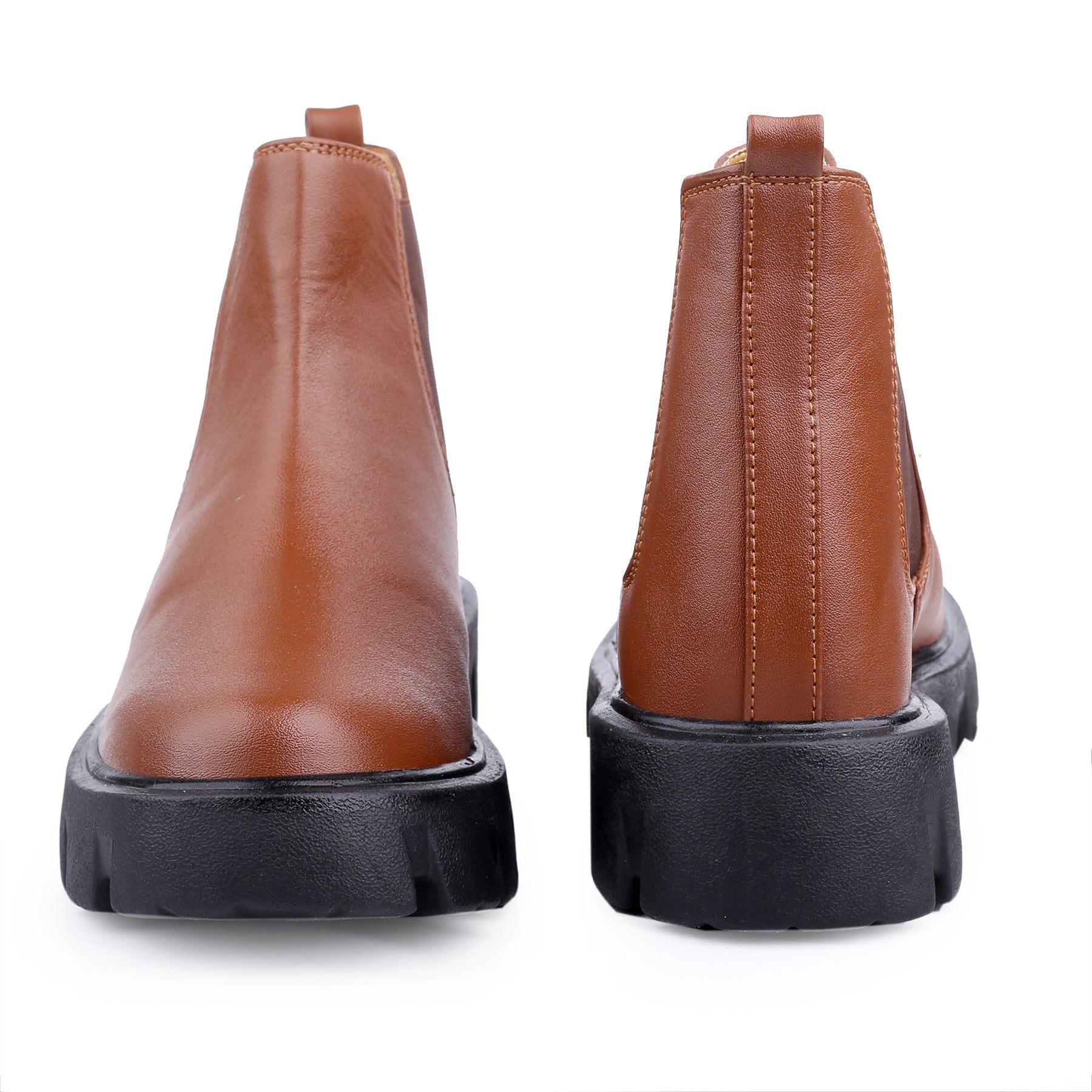 Pair of brown leather boots with black soles on a white background