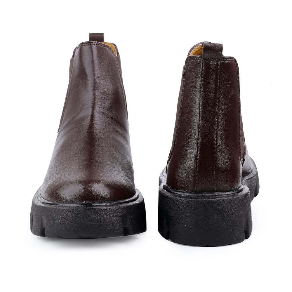 Pair of brown leather boots on a white background