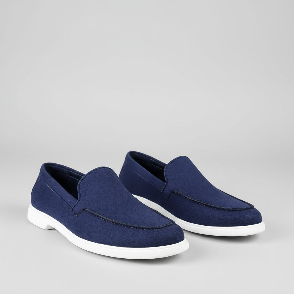 Person wearing blue loafers on a wooden floor