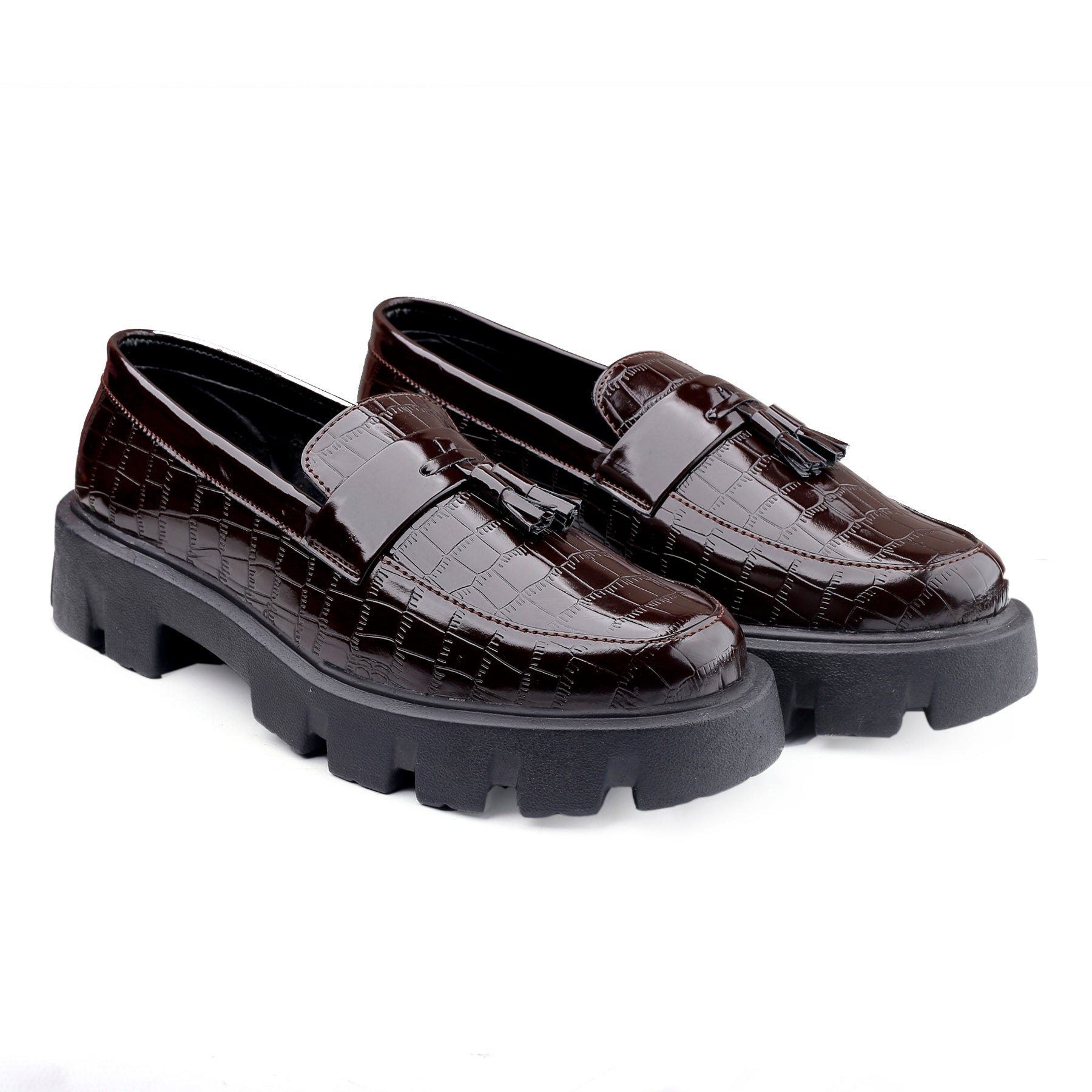 Brown loafers with chunky black soles on a white background