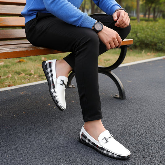 White loafers with black and gray checkered pattern on a dark surface