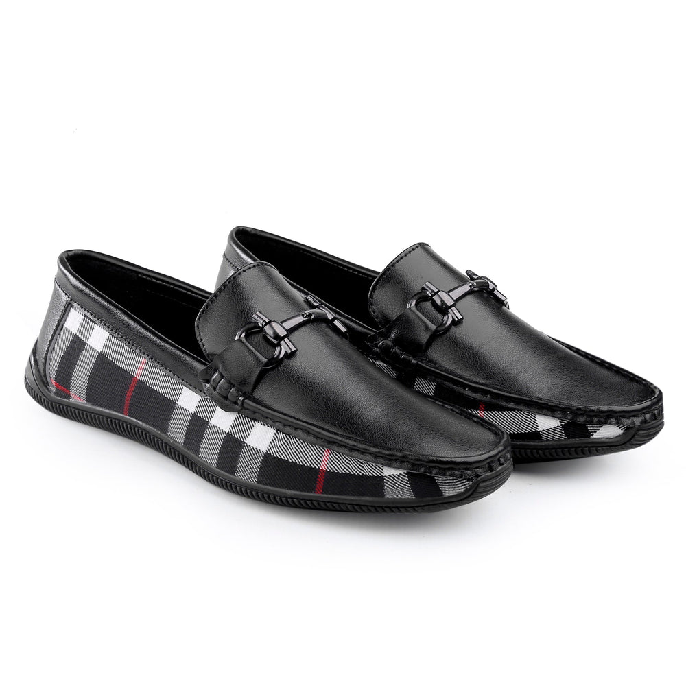 Black loafers with plaid pattern on a white background