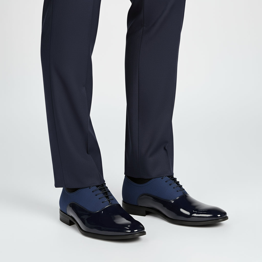 Pair of blue dress shoes with glossy finish on a white background