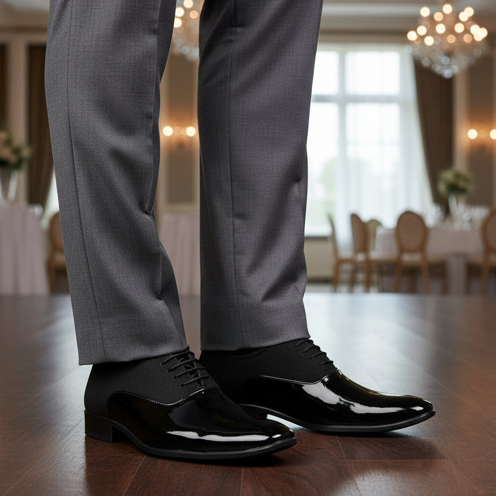 Black dress shoes with glossy finish on a white background