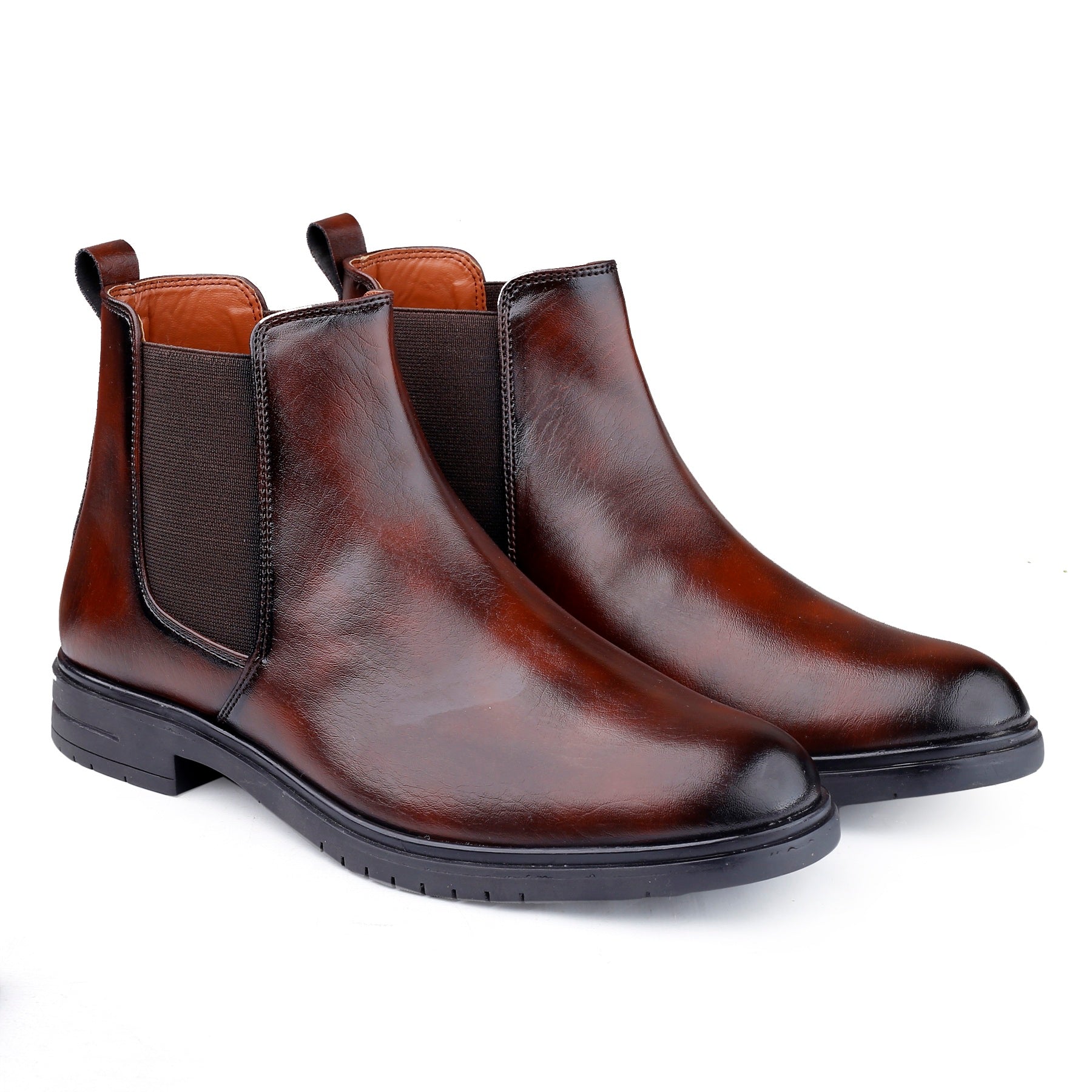 Pair of brown leather Chelsea boots on a white background