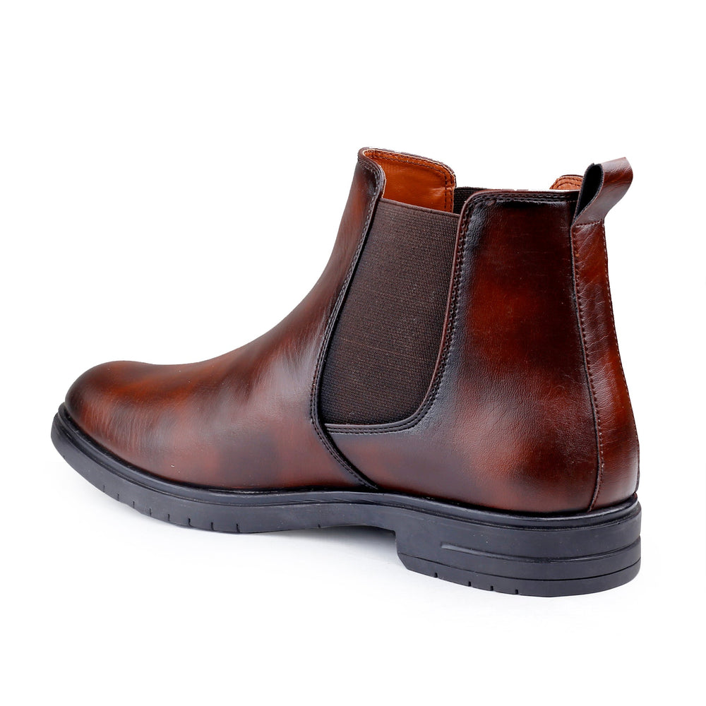 Brown leather Chelsea boot on a white background