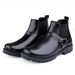 Pair of black leather boots with gold buckles on a white background