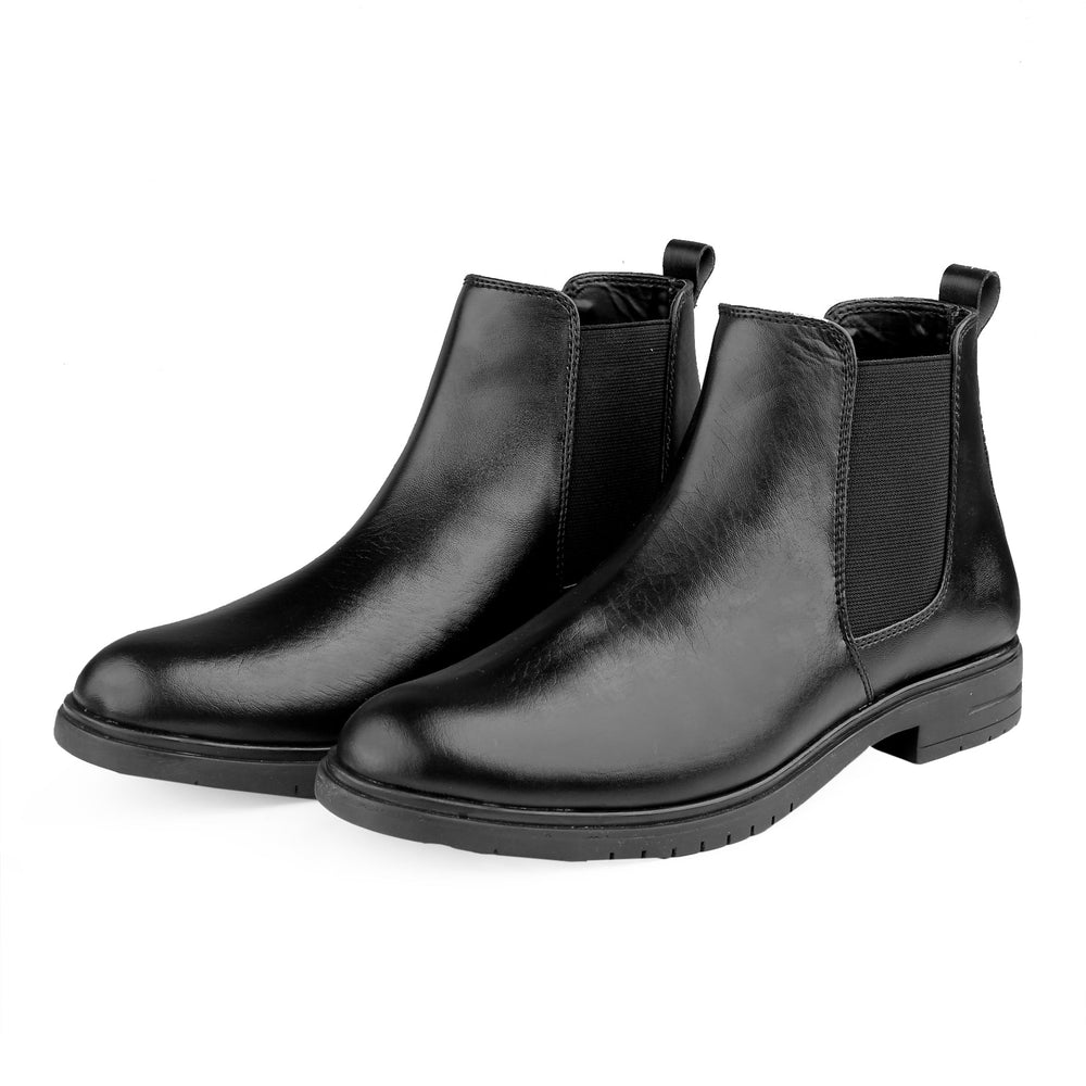Pair of black leather Chelsea boots on a white background