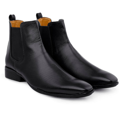 Pair of black leather ankle boots on a white background