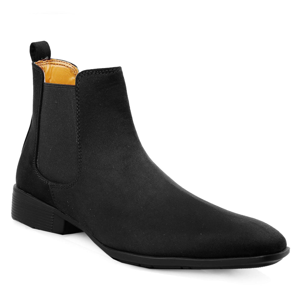 Black Chelsea boot with a yellow lining on a white background