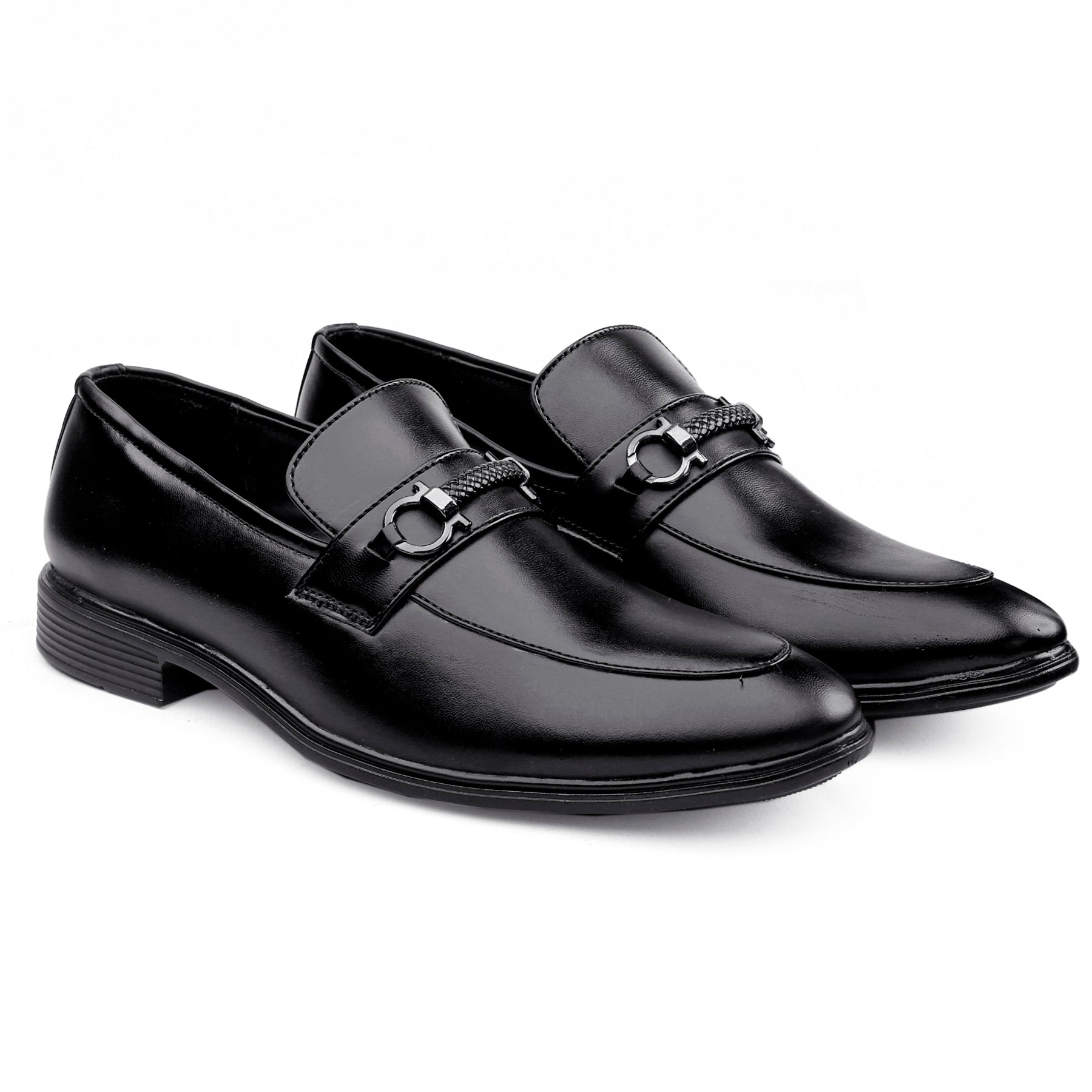 Pair of black dress shoes with a silver buckle on a white background