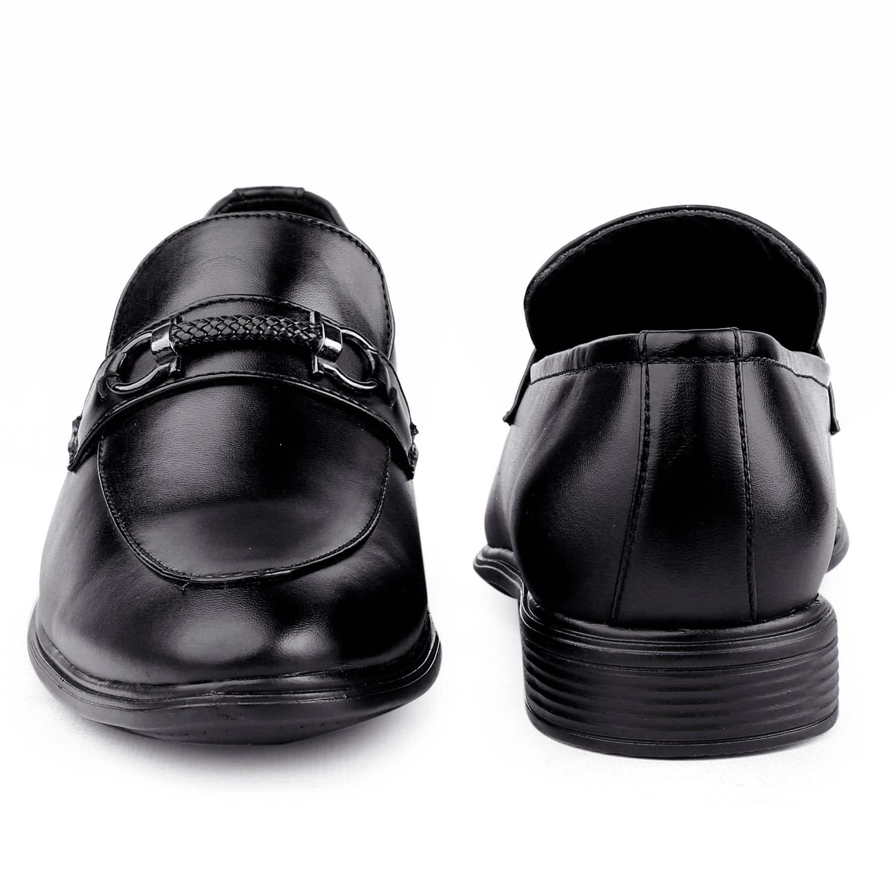 Black dress shoes with a buckle on a white background