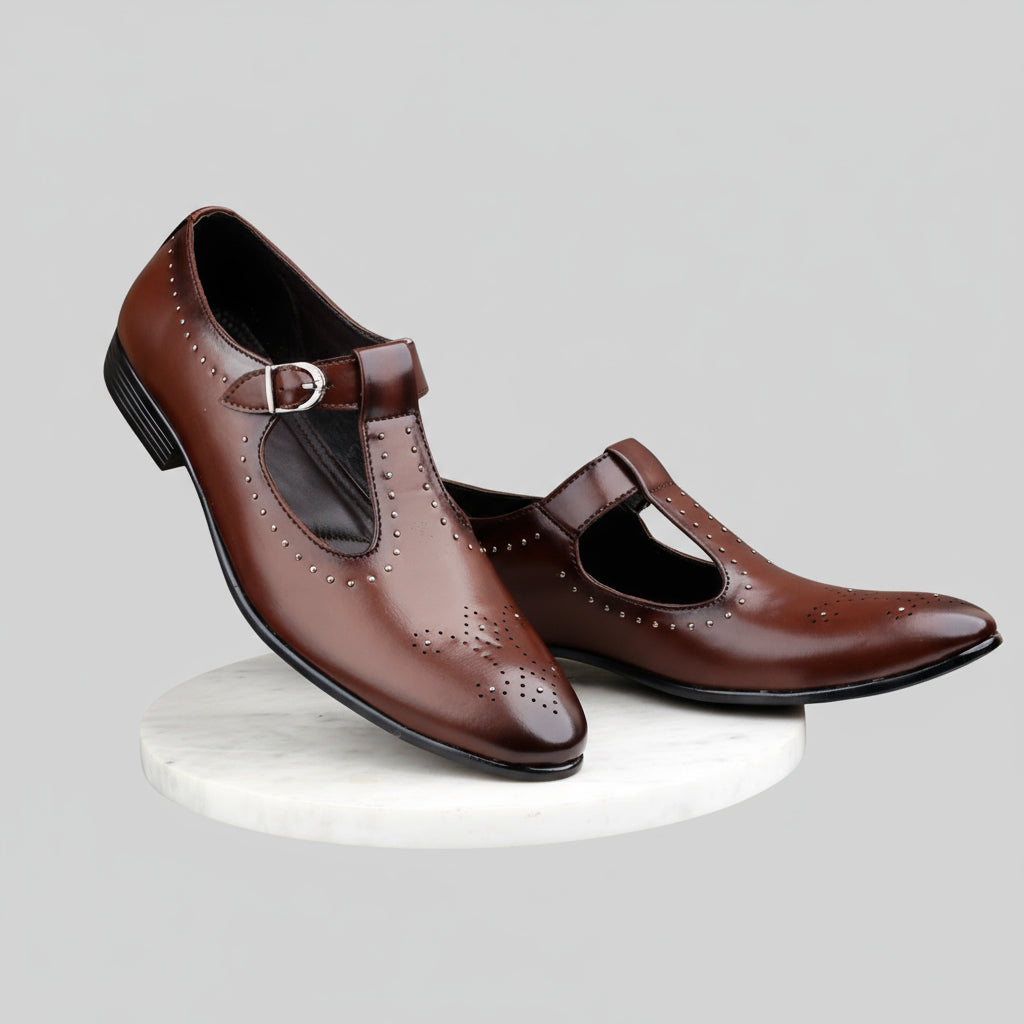 Pair of brown shoes with a strap on a reflective surface with a blurred background