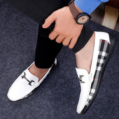White loafers with black and gray checkered pattern on a dark surface