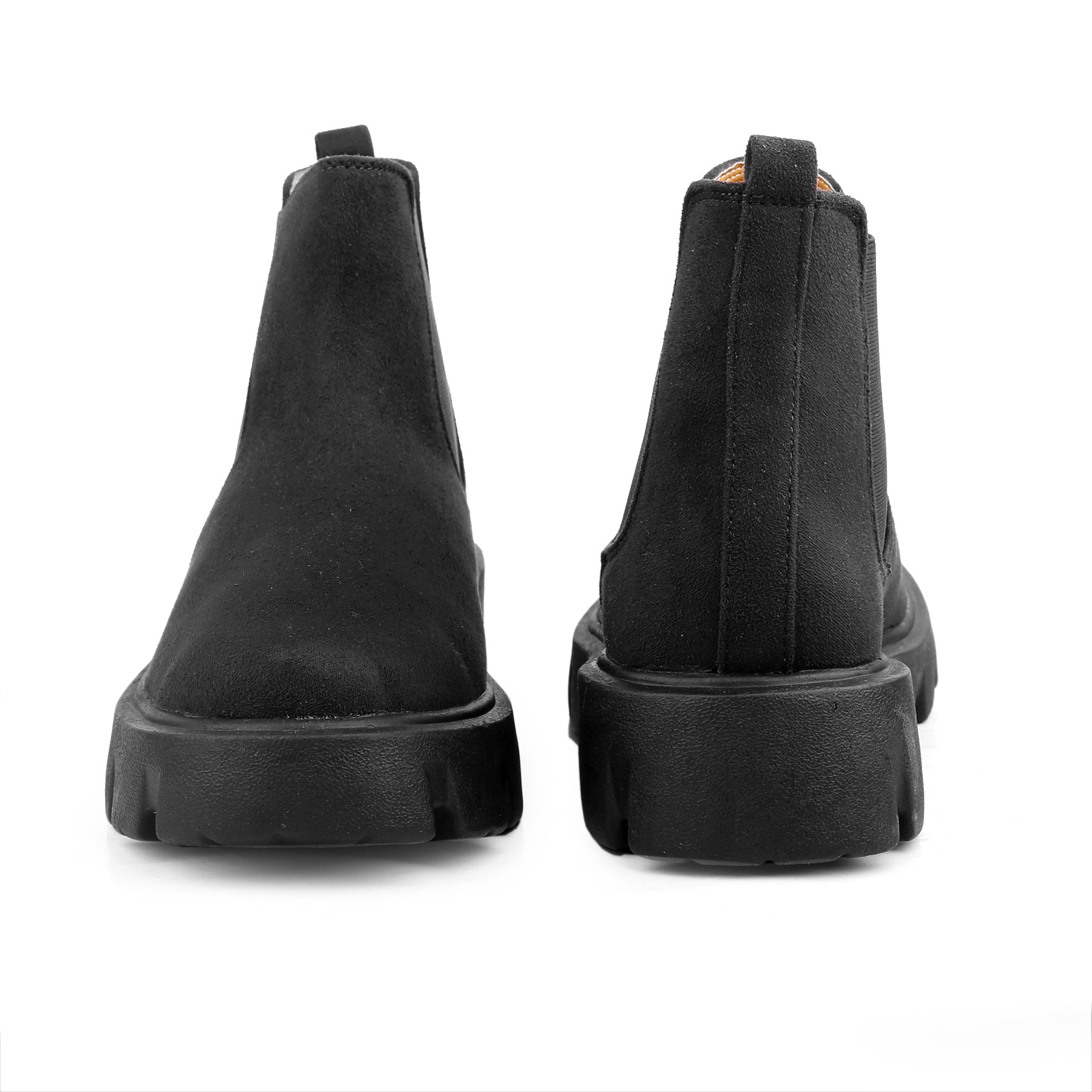 Black Chelsea boots on a white background