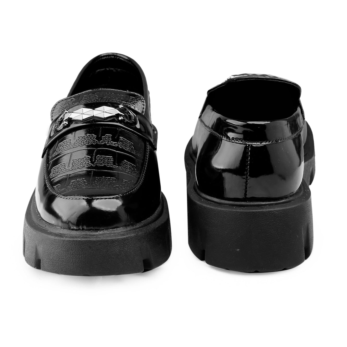 Black patent leather shoes with platform sole on a white background