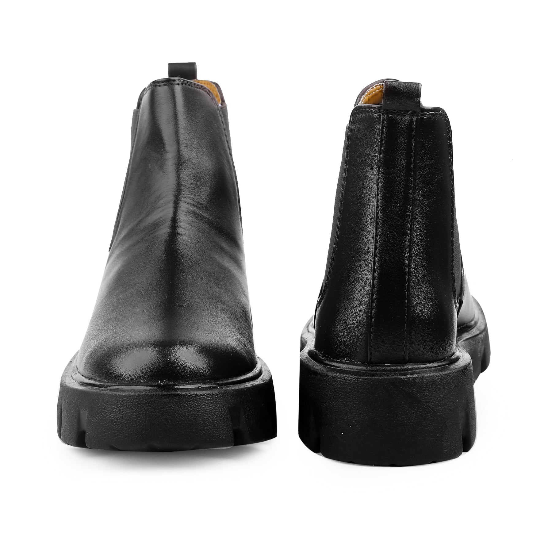 Black leather boots shown from the back on a white background