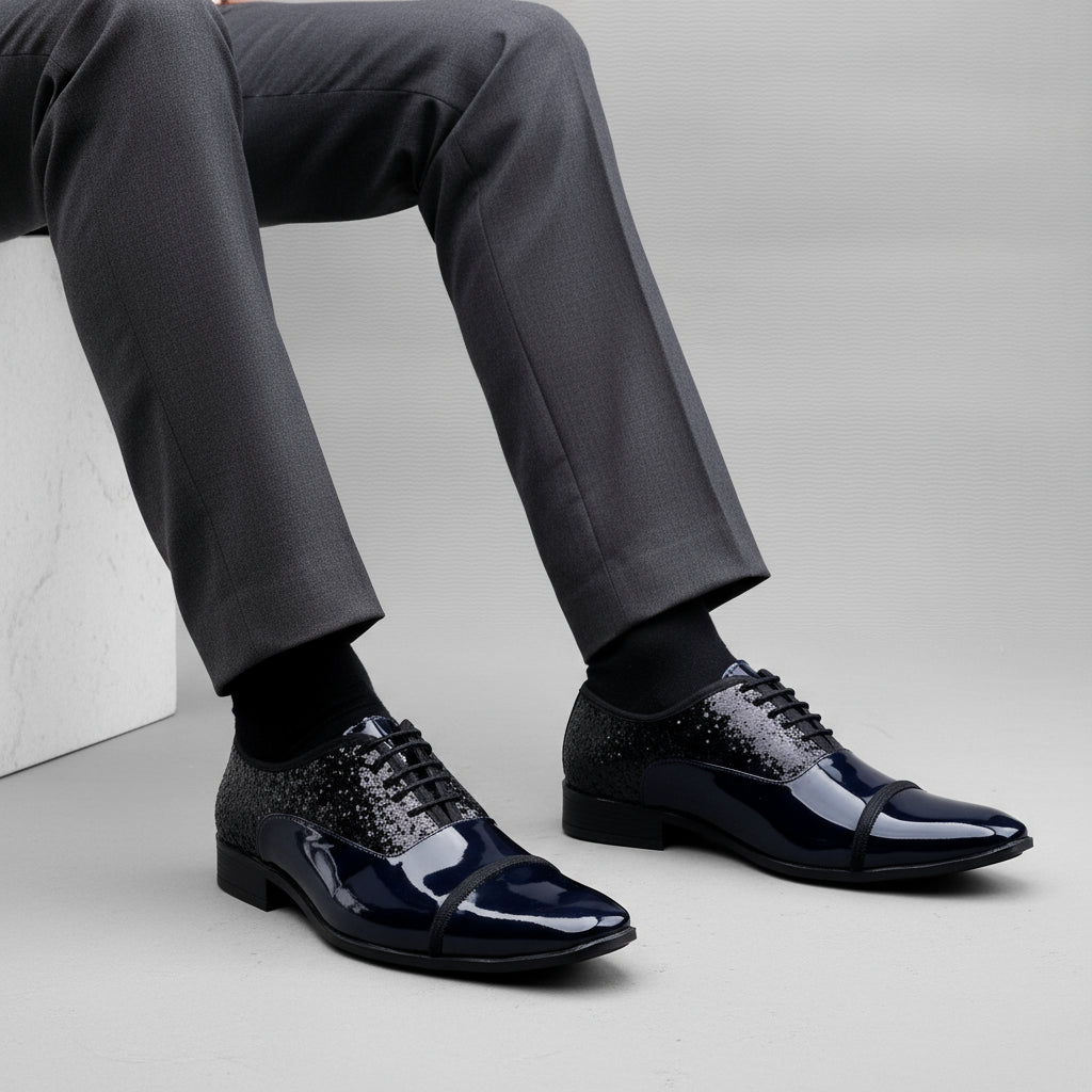 Black patent leather shoes on a white platform with a gray background