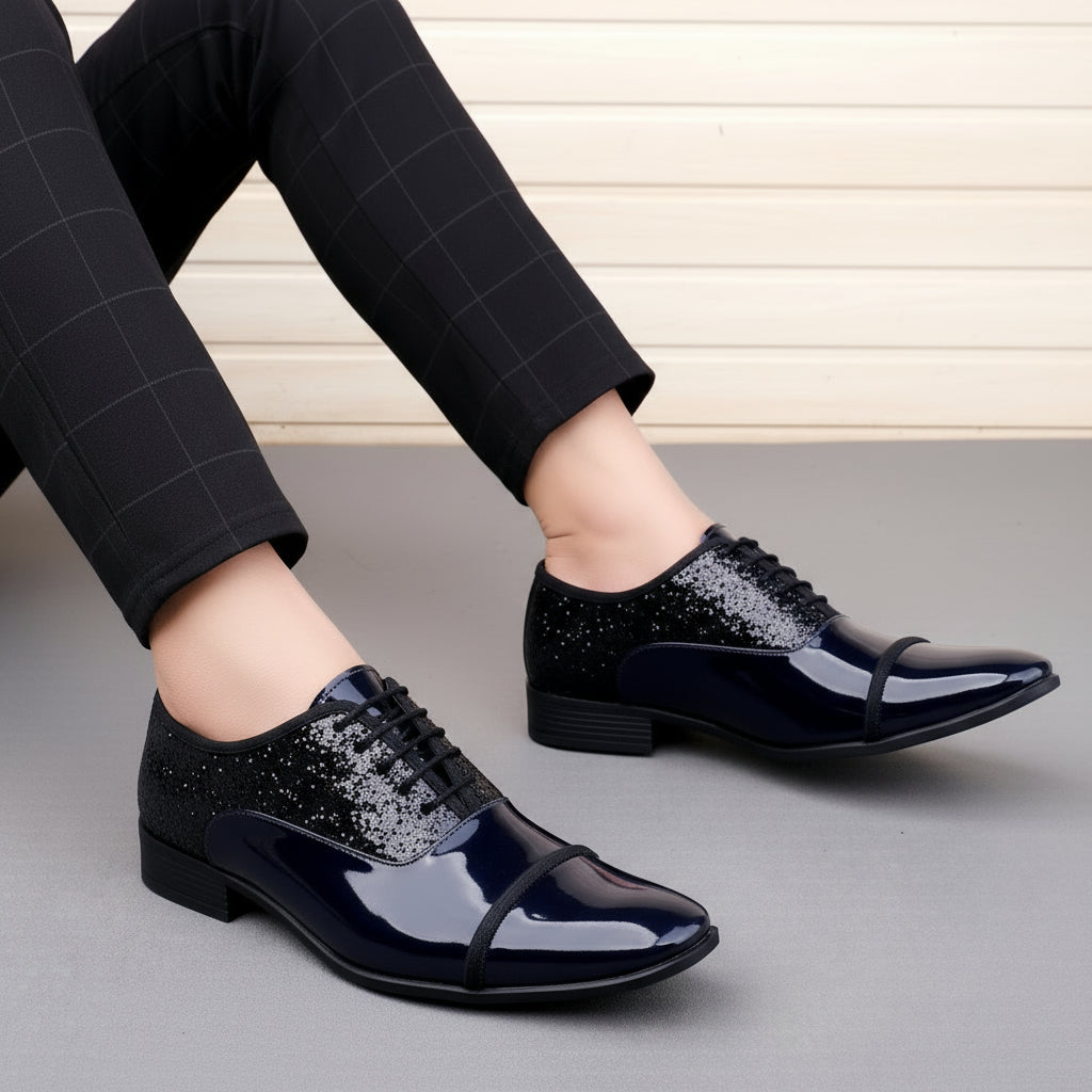 Blue patent leather shoes with glittery detailing worn by a person.
