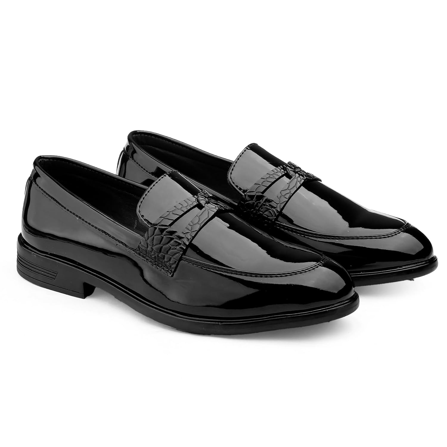 Pair of black patent leather loafers on a white background