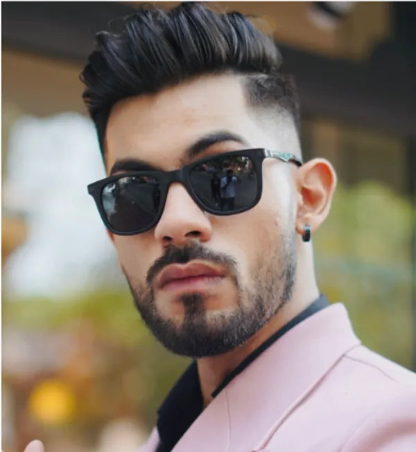Man wearing black sunglasses with a blurred background