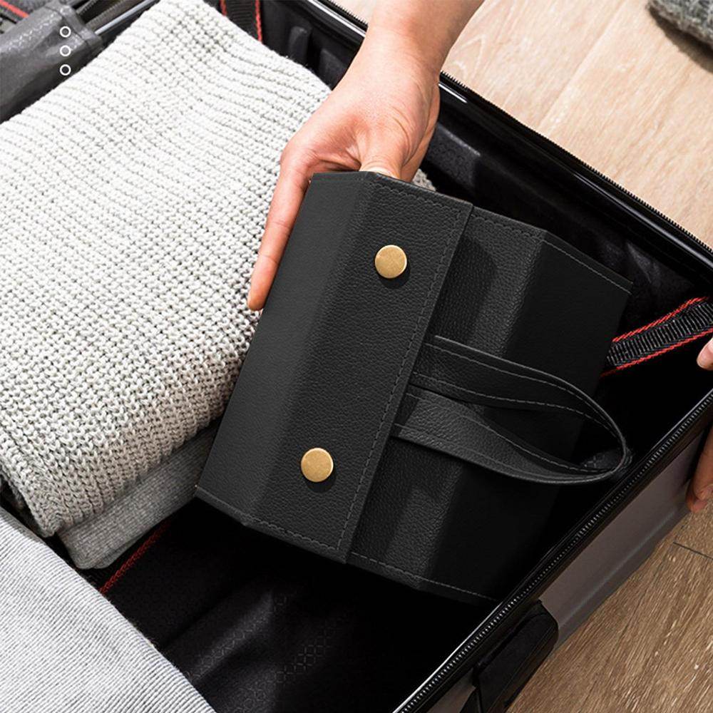 Mens Attire black sunglasses storage box being placed in suitcase beside sweater portable eyeglasses organizer